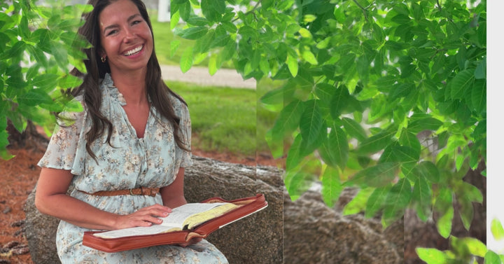 a lady sitting outside in a sweet dress on a spring day reading her Bible using a Kinsman & Company Bible Case.